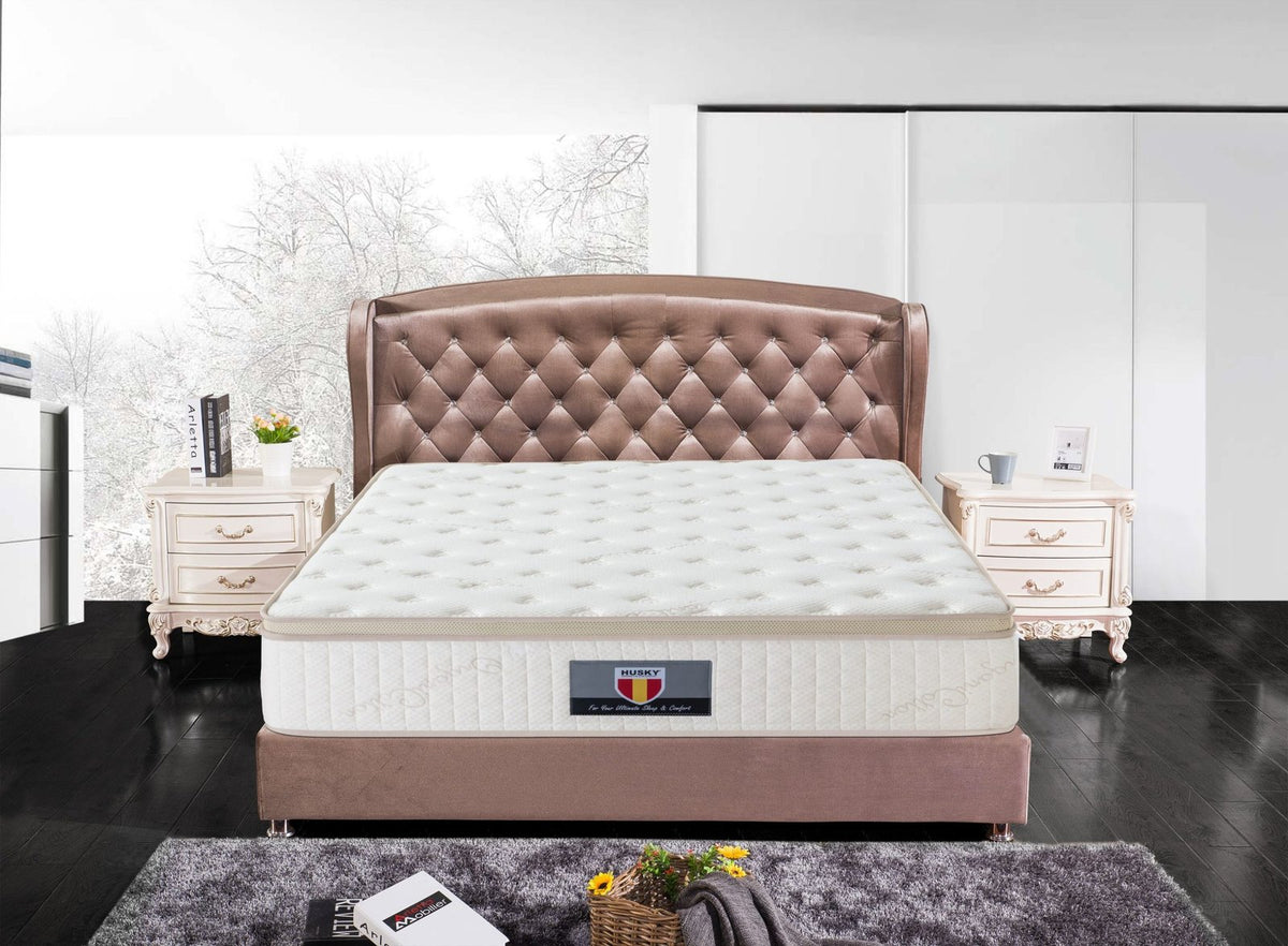 Husky Trinity mattress on an upholstered bed in a bedroom