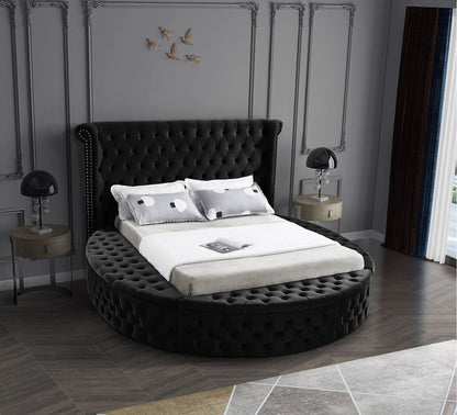 Alora round storage bed in black velvet in a bedroom, front view