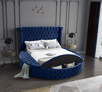 Alora storage bed in blue velvet, storage bench open in a bedroom
