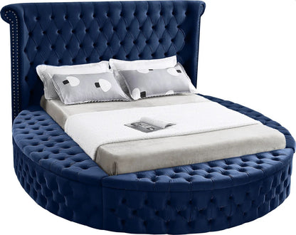 Alora round storage bed in blue velvet, white background