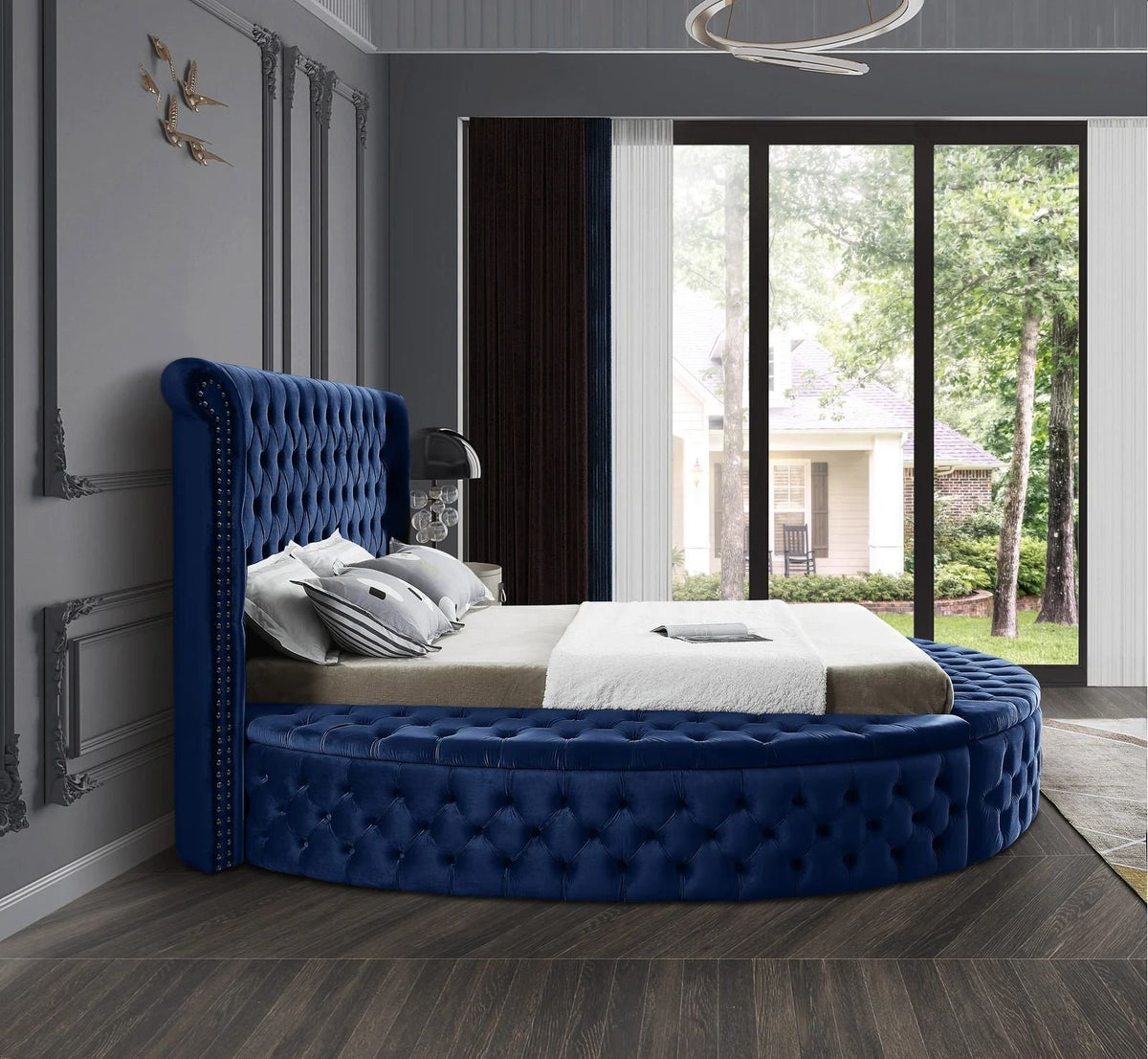 Alora round storage bed in blue velvet, side view in a bedroom