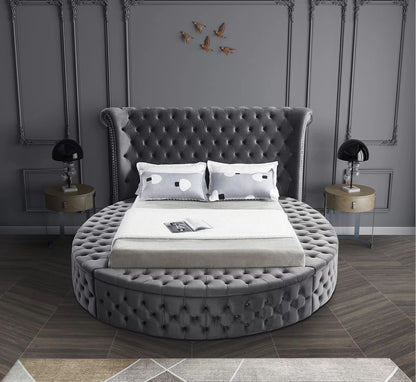 Alora round storage bed in grey velvet in a bedroom, front view