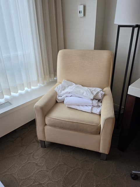 Cream accent armchair from the Ottawa hotel rooms